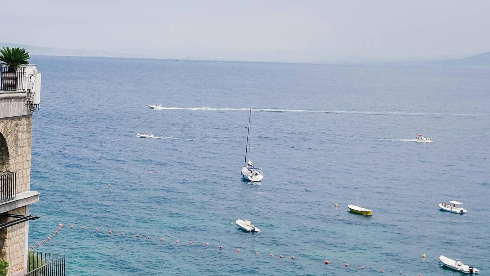 Sailing boats anchored in a turquoise Mediterranean bay